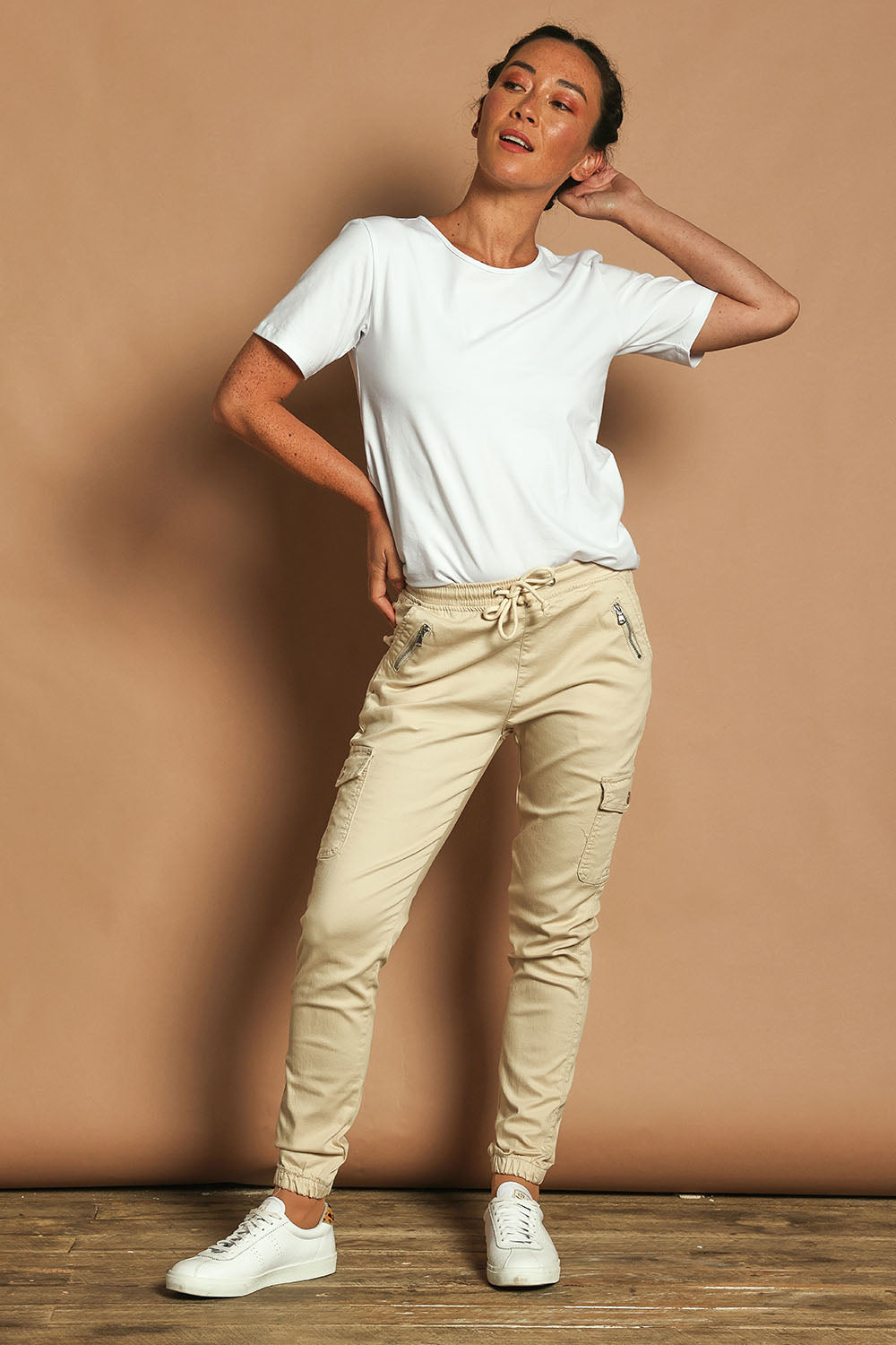 Model Katie wearing size 10 of the Harlow Cargo Jogger in colour Beige, from the front, showing the whole outfit