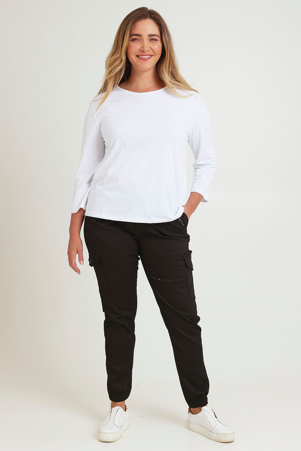 Model Chanel wearing size 16 of the Harlow Cargo Jogger in colour Black (Black), from the front, showing the whole outfit