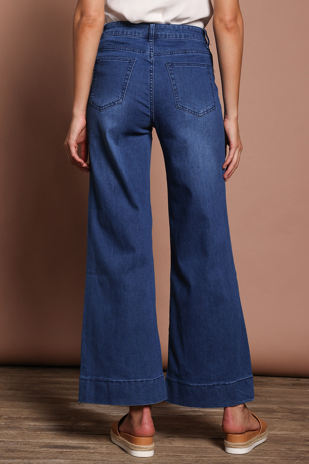 Model Madeline wearing size 9 of the Katie Highin colourWaisted Front Pocket Wide Leg Jean - Darkdenim (Blue), from the back