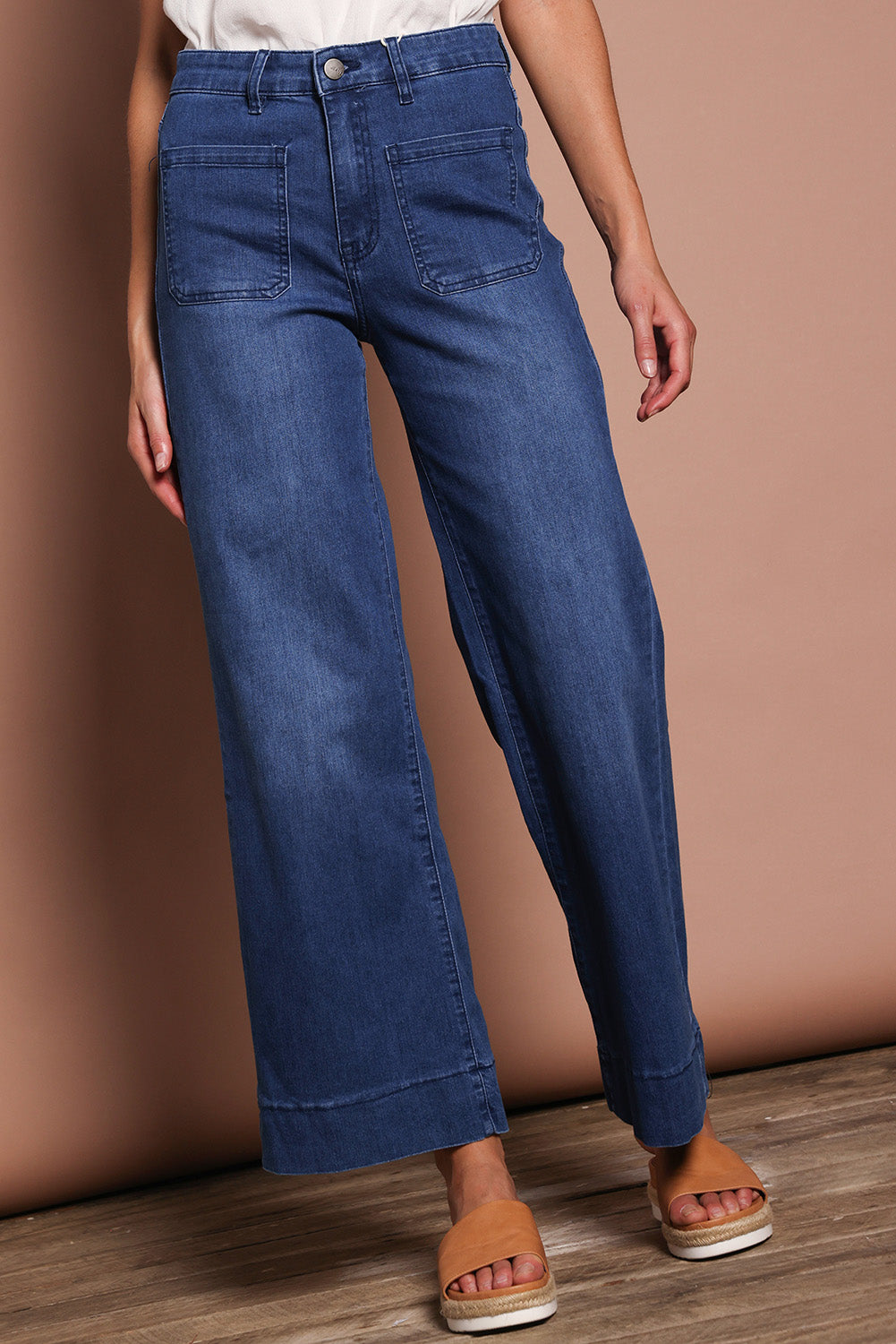 Model Madeline wearing size 9 of the Katie Highin colourWaisted Front Pocket Wide Leg Jean - Darkdenim (Blue), from the front, cropped image