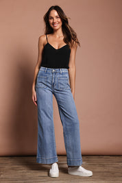 Model Madeline wearing size 9 of the Katie Highin colourWaisted Front Pocket Wide Leg Jean - Lightdenim (Blue), from the front, showing the whole outfit