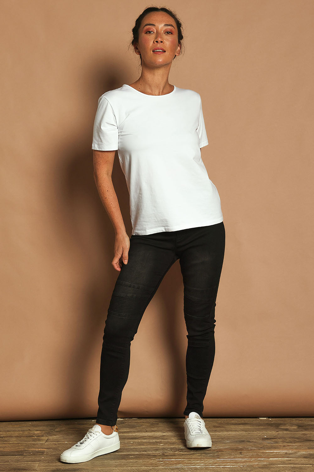 Model Katie wearing size 10 of the River Ribbed Pull On Jean in colour Black (Black), from the front, showing the whole outfit
