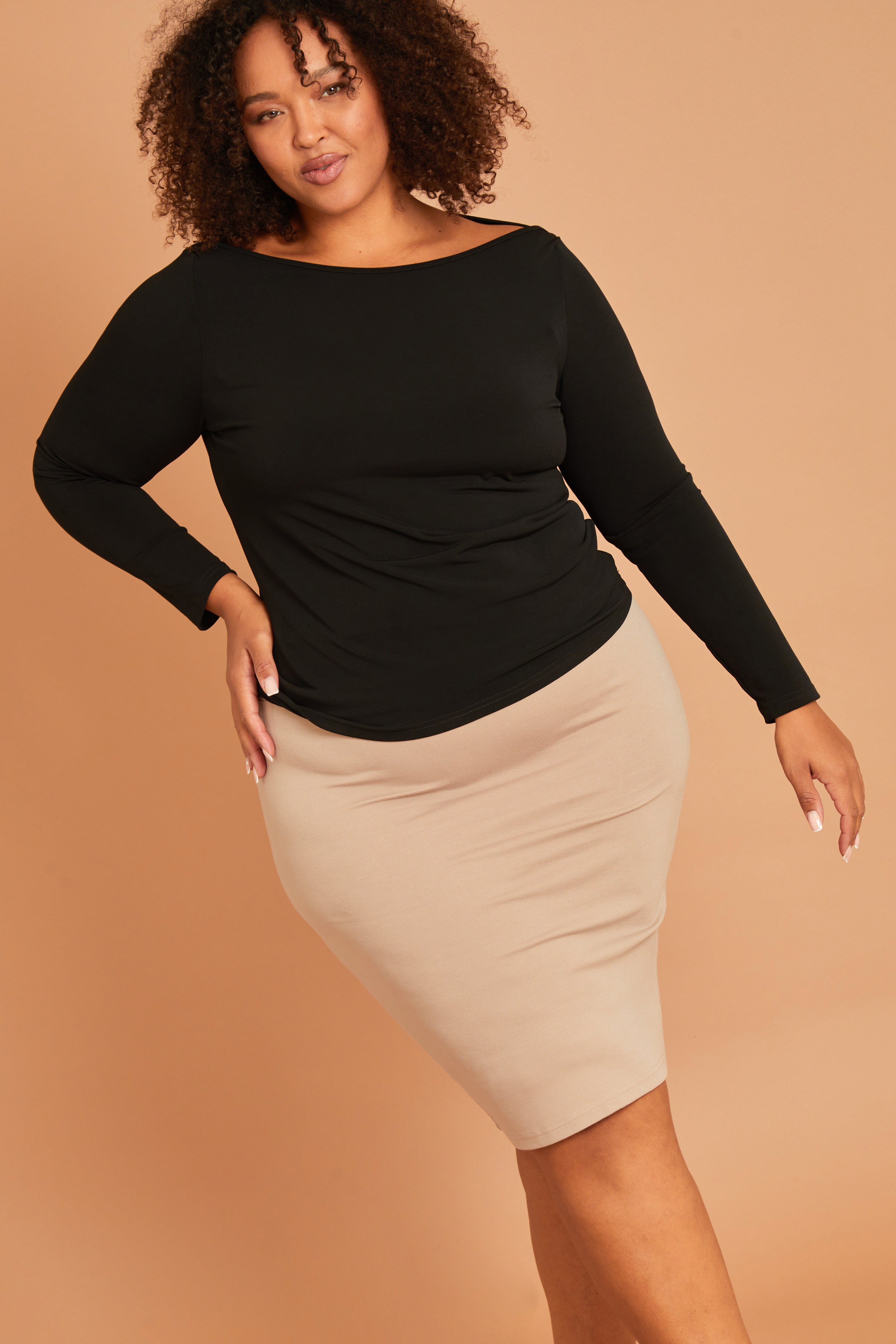 Model Alexis wearing size 16 of The Ponte Knee Length Pencil Skirt in colour Beige, from the front, showing the whole outfit
