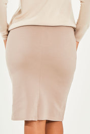 Model Noli wearing size 14 of The Ponte Knee Length Pencil Skirt in colour Beige, from the back