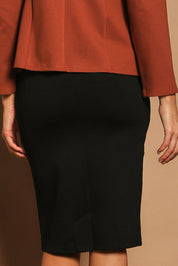Model Madeline wearing size 10 of The Ponte Knee Length Pencil Skirt in colour Black (Black), from the back