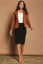 Model Madeline wearing size 10 of The Ponte Knee Length Pencil Skirt in colour Black (Black), from the front, showing the whole outfit