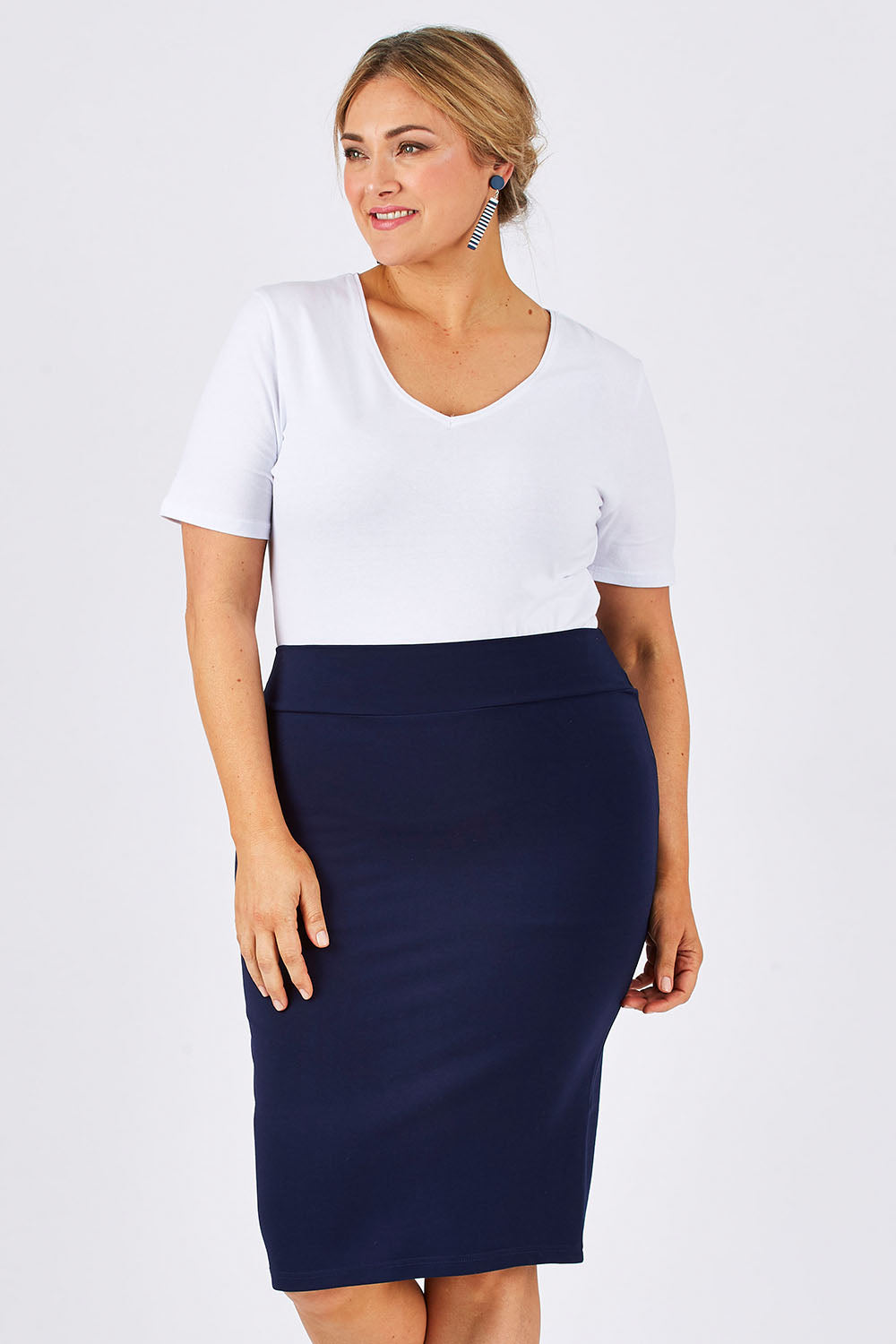 Model Ljubenka wearing size 18 of The Ponte Knee Length Pencil Skirt in colour Navy (Blue), from the front, cropped image