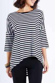 Model Andrea wearing size S of the Thin Stripe Bamboo Hi Low Top in colour Blackwhite (White), from the front, cropped image