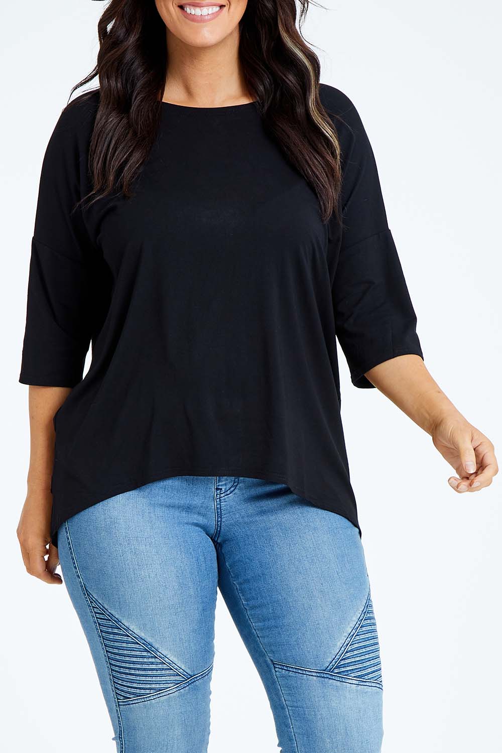 Model Laura wearing size L of the Relaxed High Low Bamboo Top in colour Black (Black), from the front, cropped image