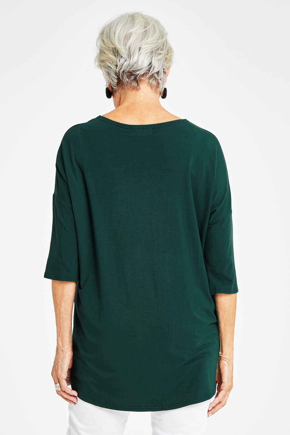 Model Elise wearing size S of the Preloved Relaxed High Low Bamboo Top in colour Forest (Green), from the back