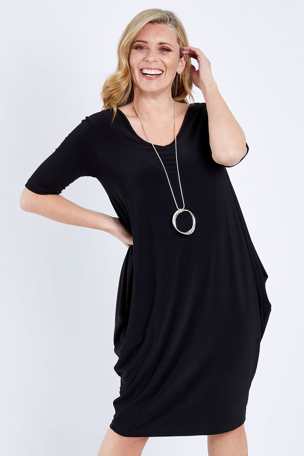 Model Brooke wearing size 10 of the Preloved Flowing V Neck Dress in colour Black (Black), from the front, cropped image