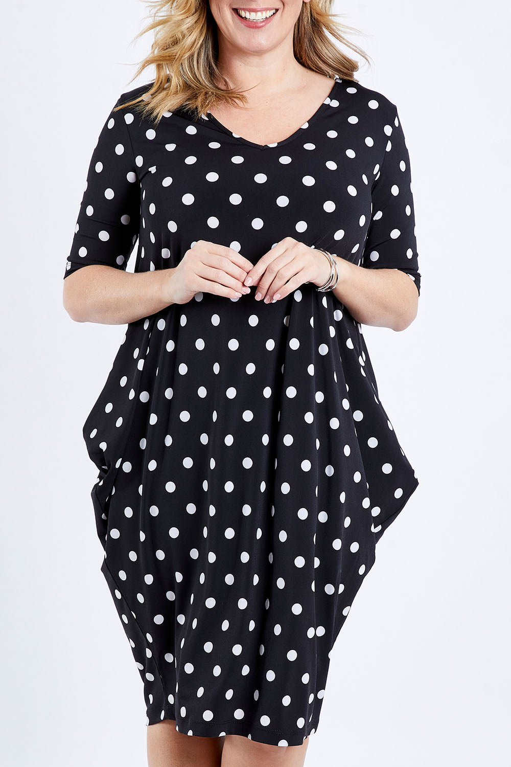 Model Brooke wearing size 10 of the Preloved Flowing V Neck Dress in colour Blkspot (Black), from the front, cropped image