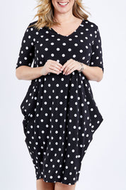 Model Brooke wearing size 10 of the Preloved Flowing V Neck Dress in colour Blkspot (Black), from the front, cropped image