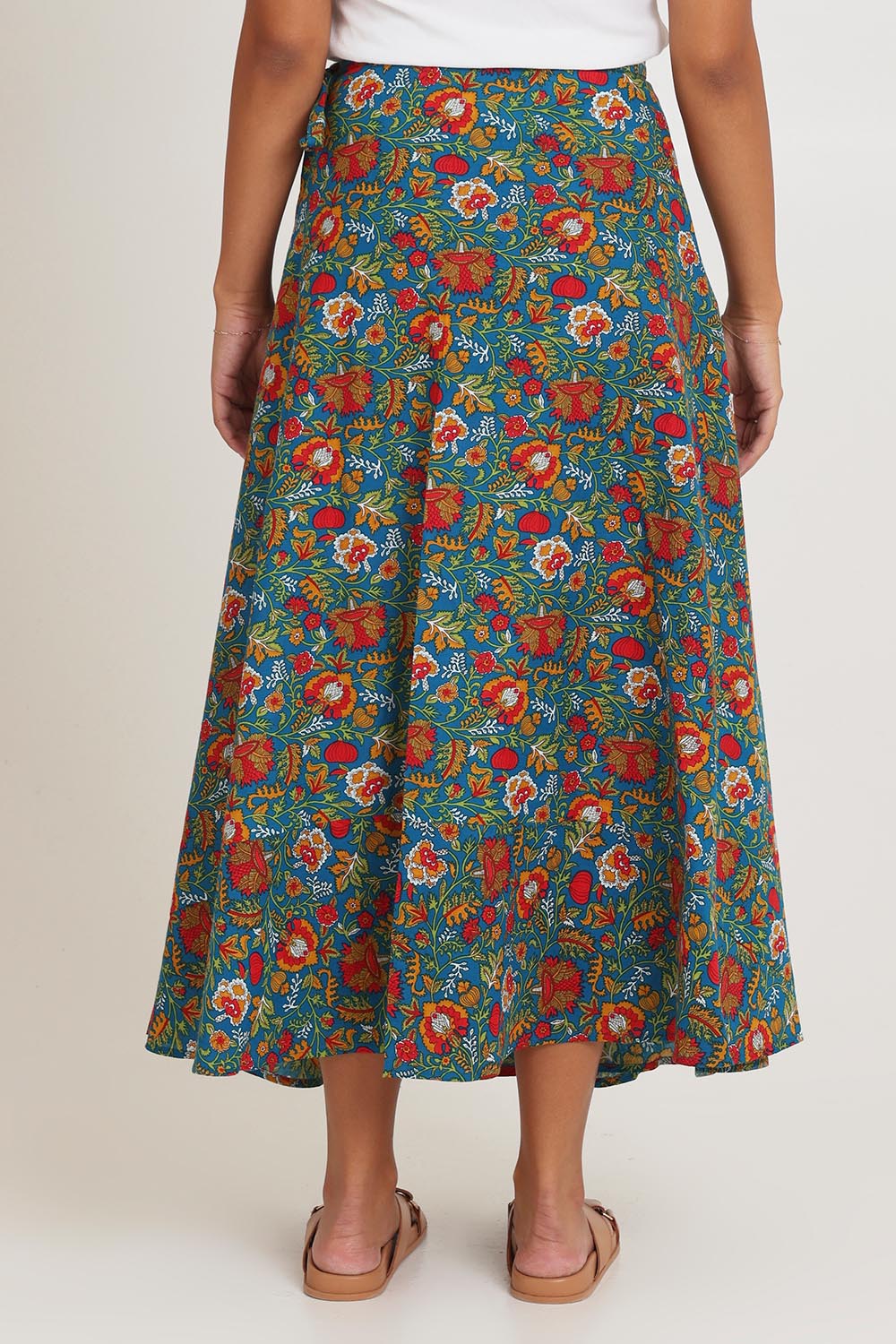 Model Ziara wearing size OneSize of the Grace Cotton Wrap Skirt in colour Valla, from the back