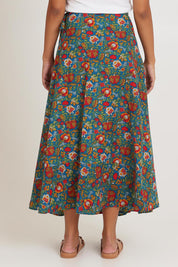 Model Ziara wearing size OneSize of the Grace Cotton Wrap Skirt in colour Valla, from the back