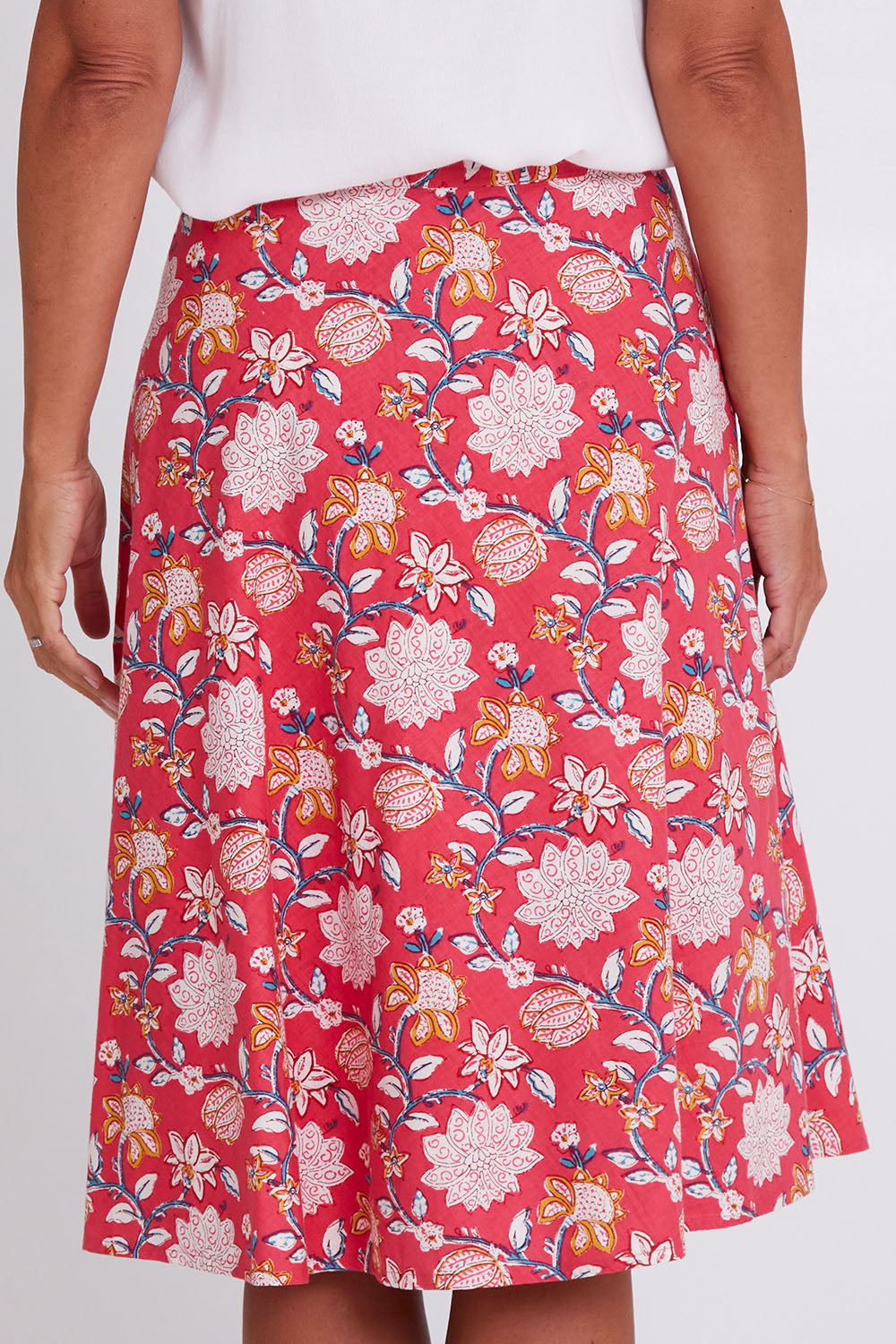 Model Alex wearing size OneSize of the Beth Wrap Skirt in colour Asterprint (Pink), from the back
