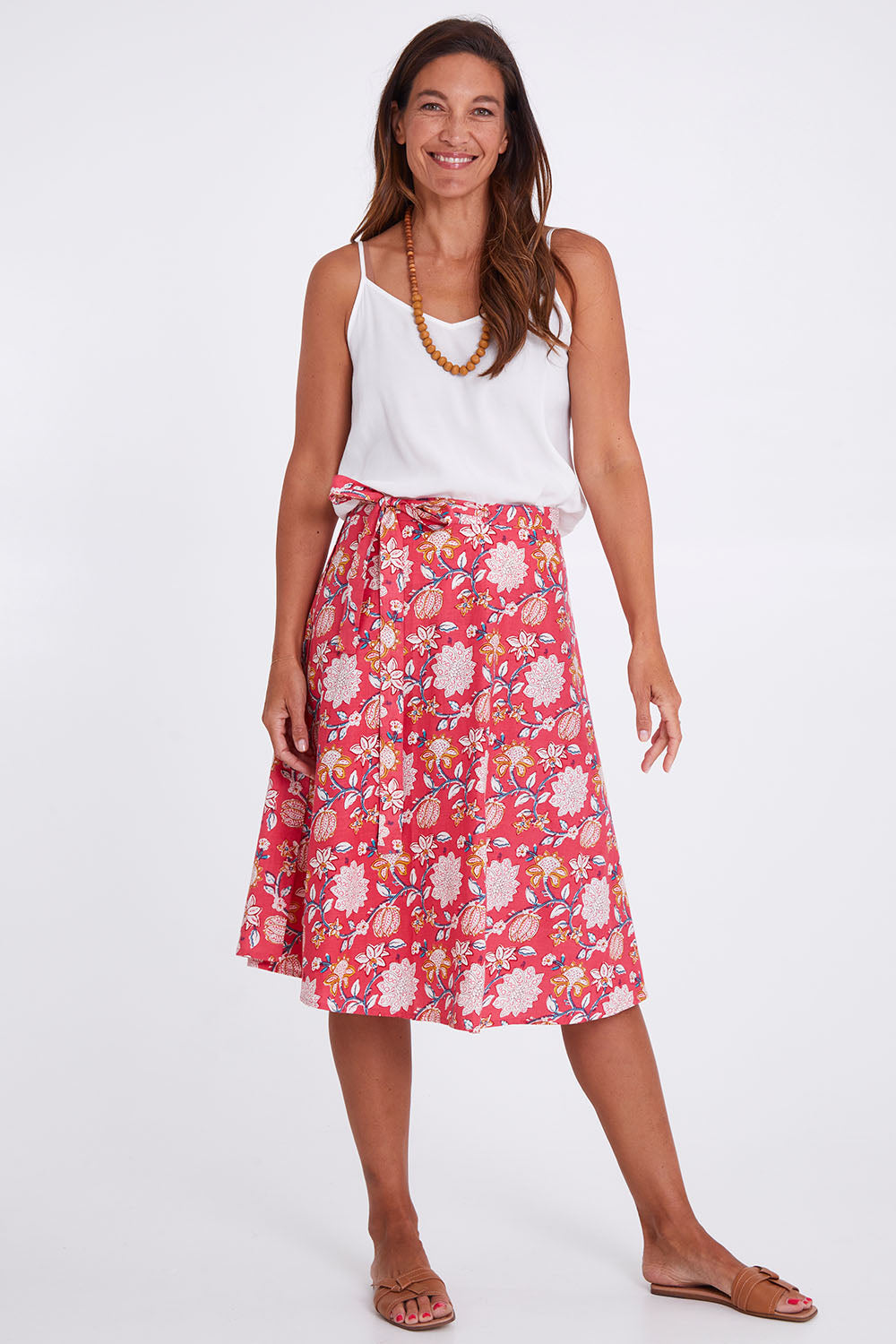 Model Alex wearing size OneSize of the Beth Wrap Skirt in colour Asterprint (Pink), from the front, showing the whole outfit