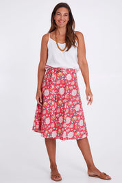 Model Alex wearing size OneSize of the Beth Wrap Skirt in colour Asterprint (Pink), from the front, showing the whole outfit