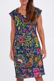Model Alex wearing size S of the Cassy Dress in colour Irisprint (Blue), from the front, cropped image