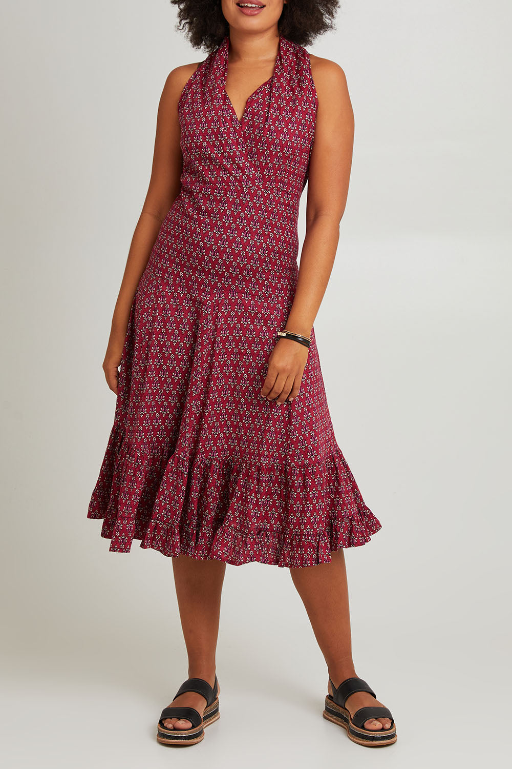 Model Olivia wearing size S-M of the Polly Tiered Dress in colour Corfu (Red), from the front, cropped image