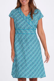 Model Alex wearing size S of the Astrid Dress in colour Emmaprint (Blue), from the front, cropped image