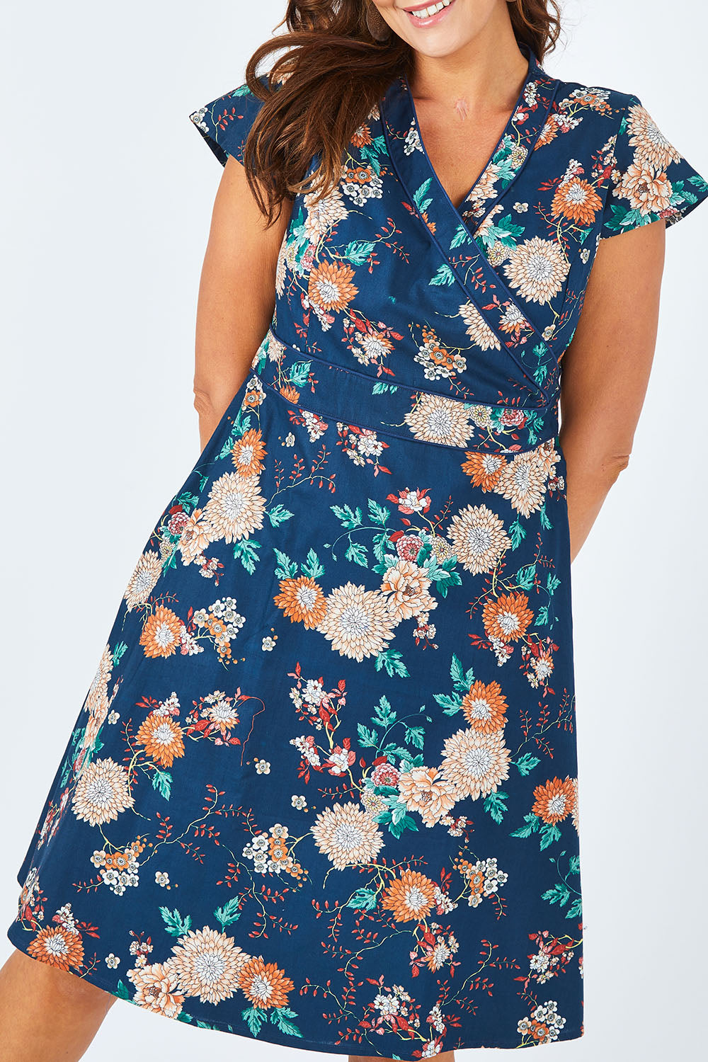 Model Abby wearing size L of the Astrid Dress in colour Maya (Blue), from the front, cropped image