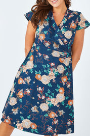 Model Abby wearing size L of the Astrid Dress in colour Maya (Blue), from the front, cropped image