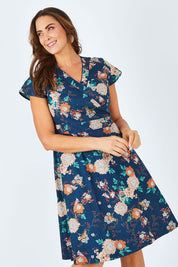 Model Abby wearing size L of the Astrid Dress in colour Maya (Blue), from the front, cropped image