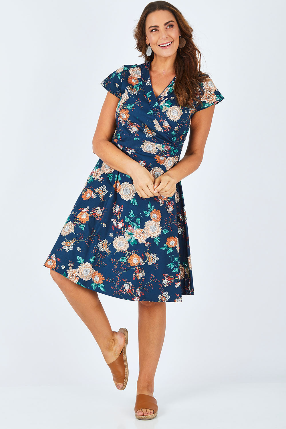 Model Abby wearing size L of the Astrid Dress in colour Maya (Blue), from the front, showing the whole outfit