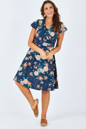 Model Abby wearing size L of the Astrid Dress in colour Maya (Blue), from the front, showing the whole outfit