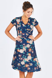 Model Madeline wearing size S of the Astrid Dress in colour Maya (Blue), from the front, cropped image