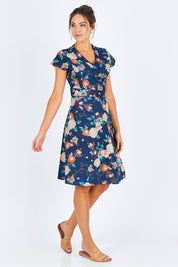 Model Madeline wearing size S of the Astrid Dress in colour Maya (Blue), from the front, showing the whole outfit