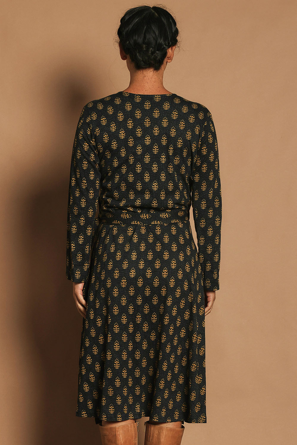 Model Katie wearing size S of the Sunburst Cotton Wrap Dress in colour Acton (Black), from the back