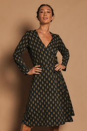 Model Katie wearing size S of the Sunburst Cotton Wrap Dress in colour Acton (Black), from the front, cropped image