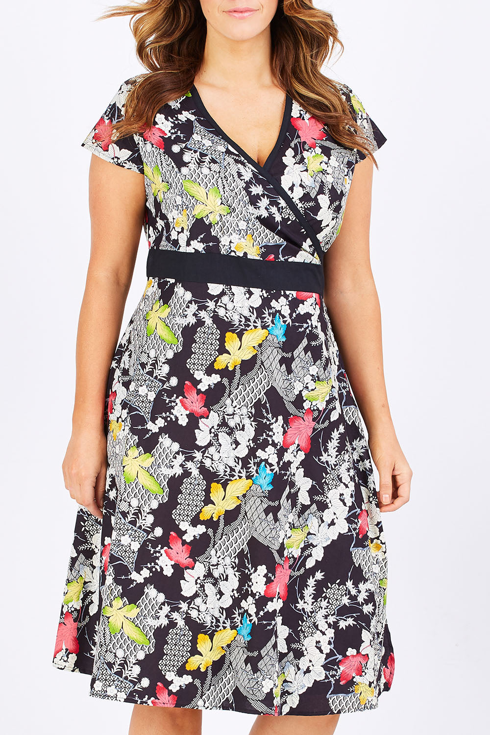 Model Laura wearing size M of the Leela Print Cotton Wrap Dress in colour Nikko (Black), from the front, cropped image