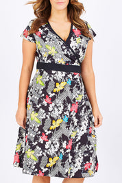 Model Laura wearing size M of the Leela Print Cotton Wrap Dress in colour Nikko (Black), from the front, cropped image