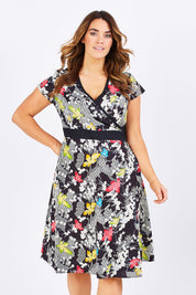Model Laura wearing size M of the Leela Print Cotton Wrap Dress in colour Nikko (Black), from the front, cropped image