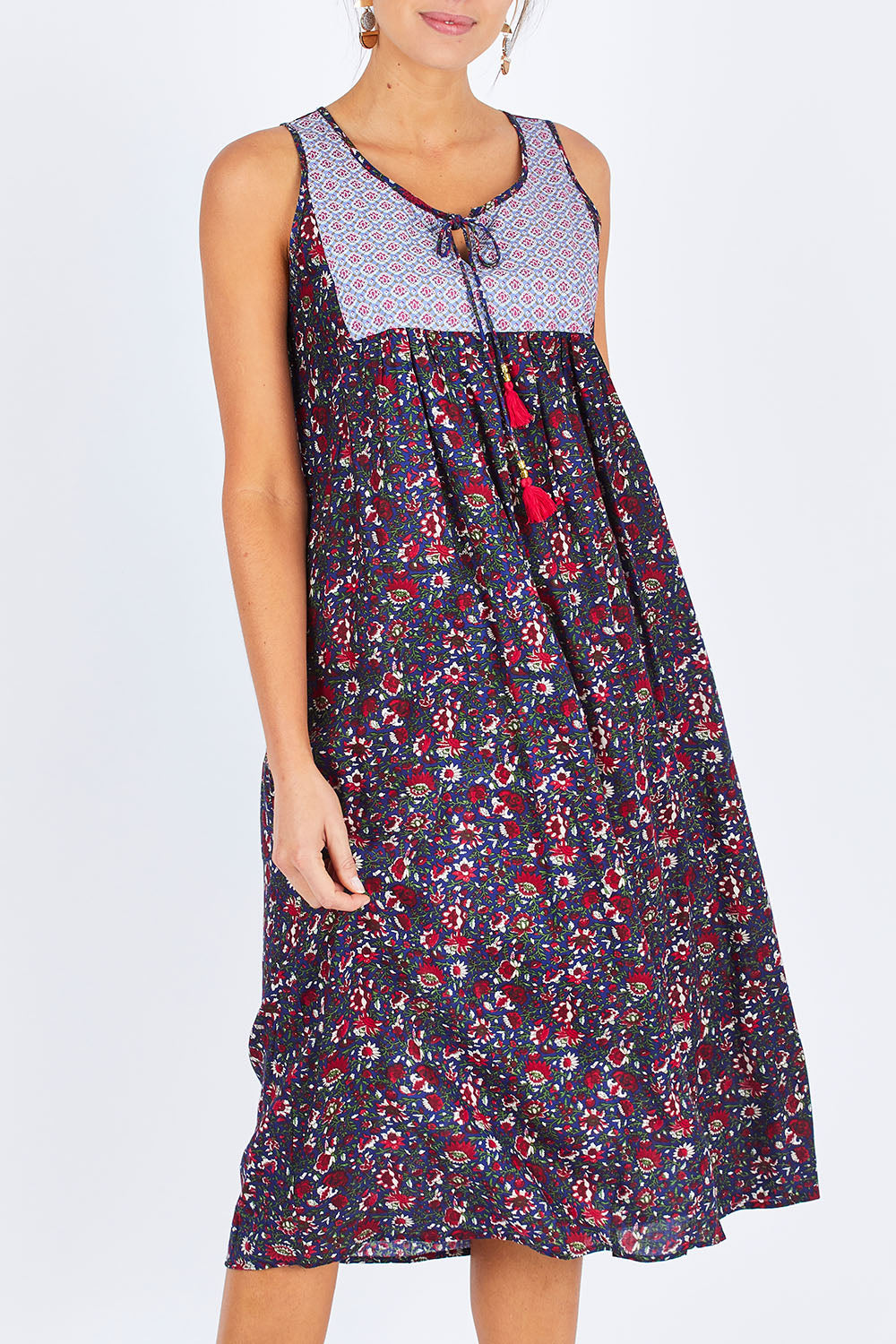 Model Madeline wearing the Goa Dress in colour NavyFlower (Blue), from the front, cropped image