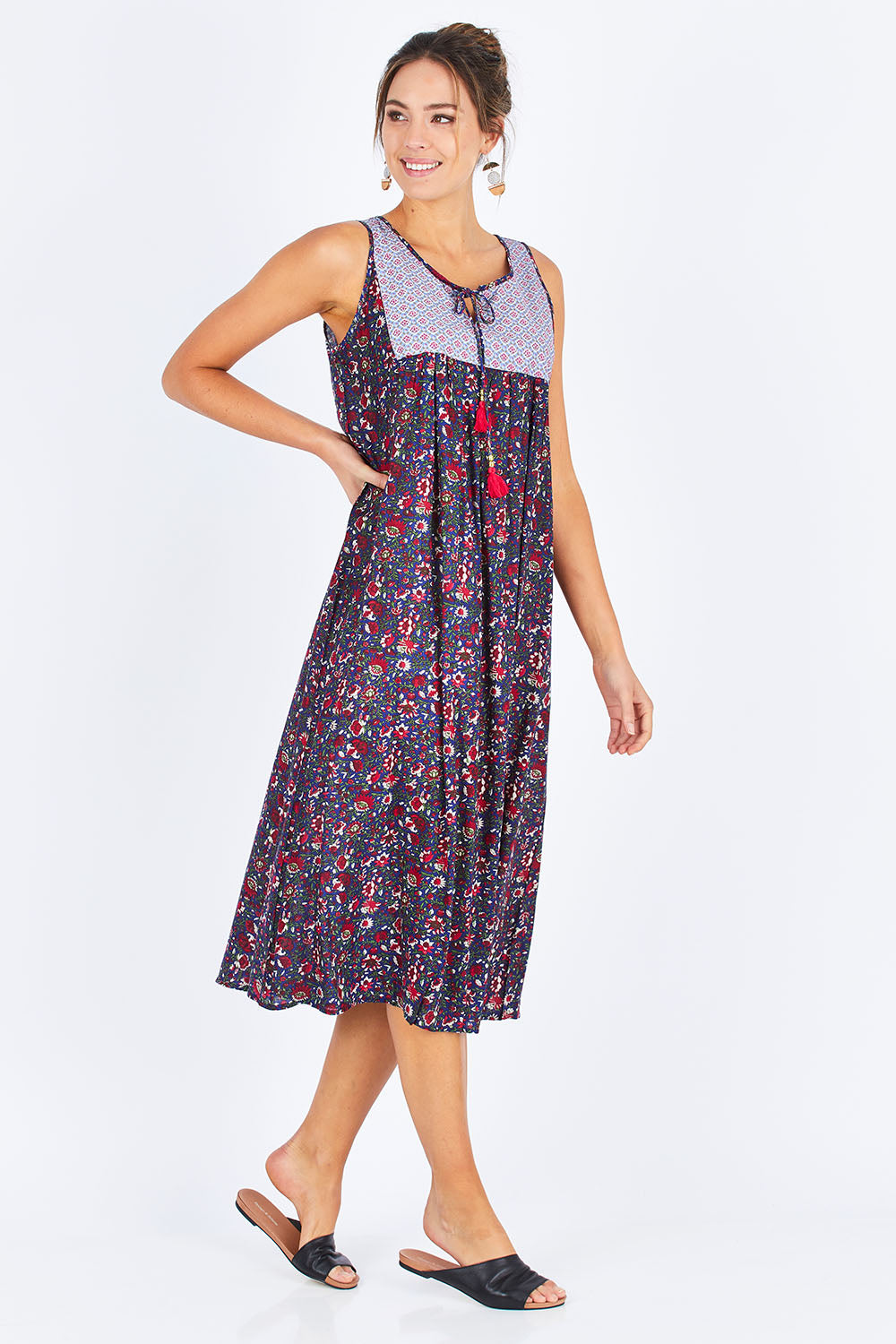 Model Madeline wearing the Goa Dress in colour NavyFlower (Blue), from the front, showing the whole outfit