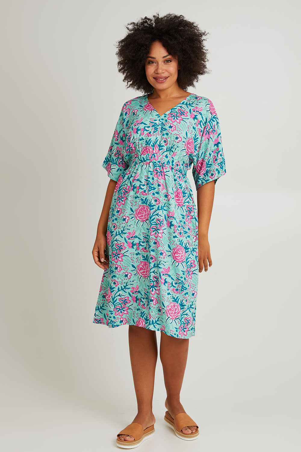 Model Olivia wearing the Evie Dress in colour Crete (Blue), from the front, showing the whole outfit