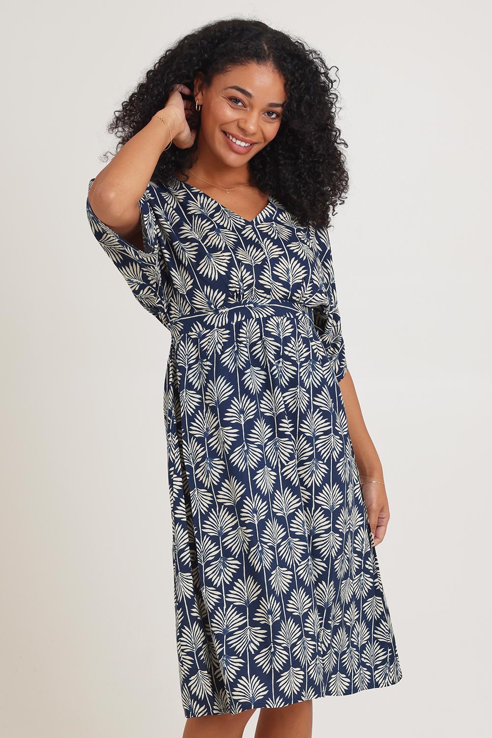 Model Ziara wearing the Evie Dress in colour Yamba, from the front, cropped image