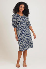 Model Ziara wearing the Evie Dress in colour Yamba, from the front, showing the whole outfit
