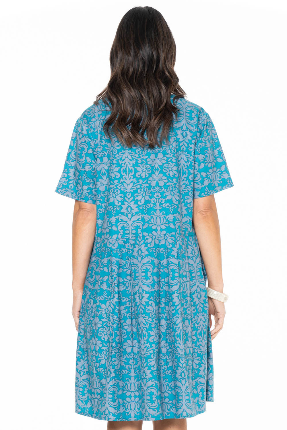 A model wearing the Billie Dress in colour Berlin (Blue), from the back