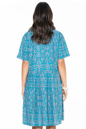 A model wearing the Billie Dress in colour Berlin (Blue), from the back