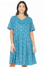 A model wearing the Billie Dress in colour Berlin (Blue), from the front, cropped image
