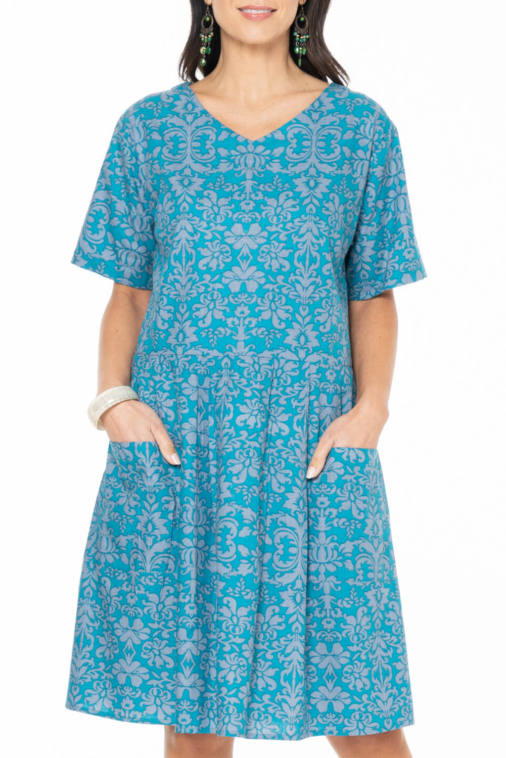 A model wearing the Billie Dress in colour Berlin (Blue), from the front, cropped image