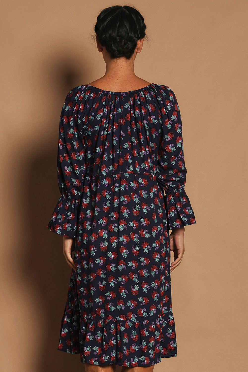 Model Katie wearing the Valeria Dress in colour Soho (Blue), from the back