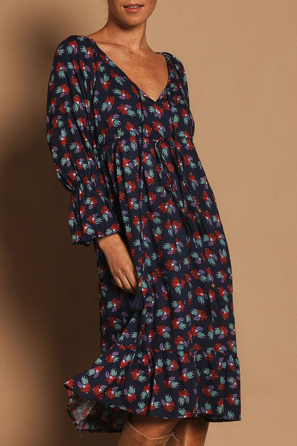 Model Katie wearing the Valeria Dress in colour Soho (Blue), from the front, cropped image