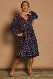 Model Katie wearing the Valeria Dress in colour Soho (Blue), from the front, showing the whole outfit