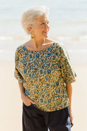 Model Elise wearing size S of the Ruth Reversible Top in colour Geneva, from the front, showing the whole outfit